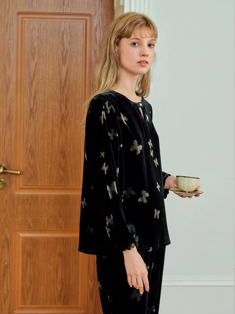 Side view of the black Silk Velvet butterfly pajama top, round neckline with keyhole